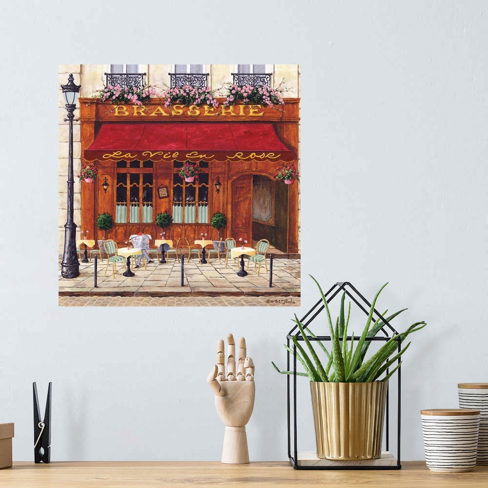 A bohemian room featuring Painting of a Parisian cafe with seating out front.