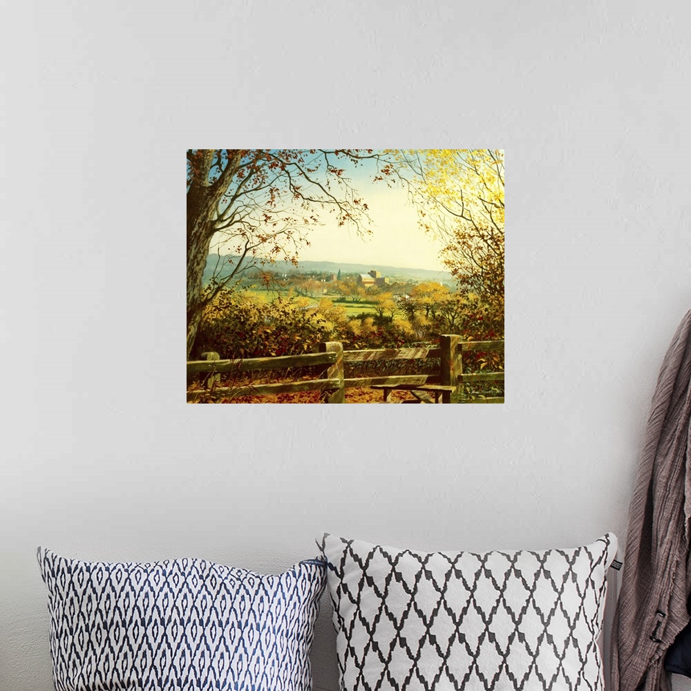 A bohemian room featuring Idyllic painting of a rural landscape, with a village in the distance.