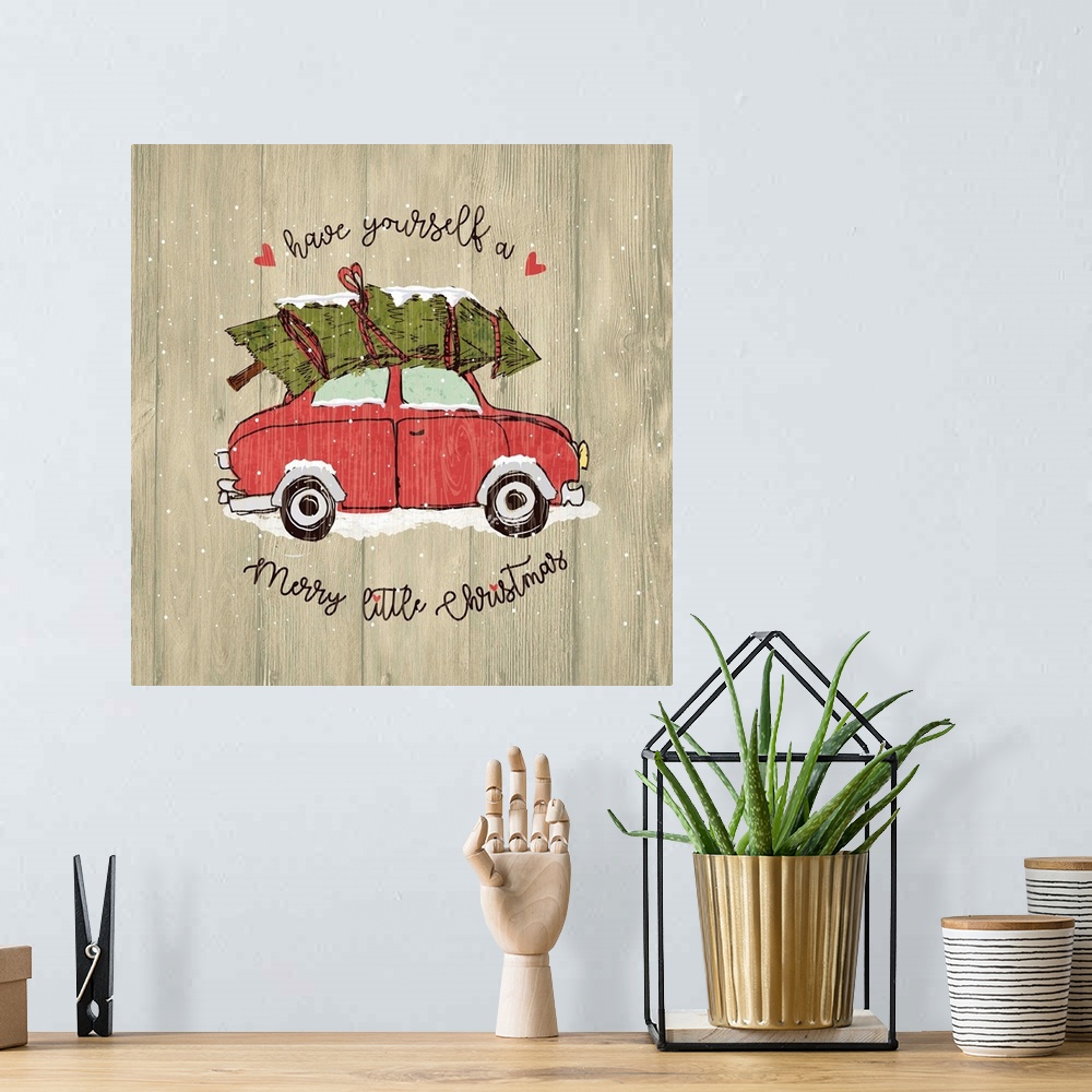 A bohemian room featuring Christmas decor of a car carrying a Christmas tree on a wooden background.