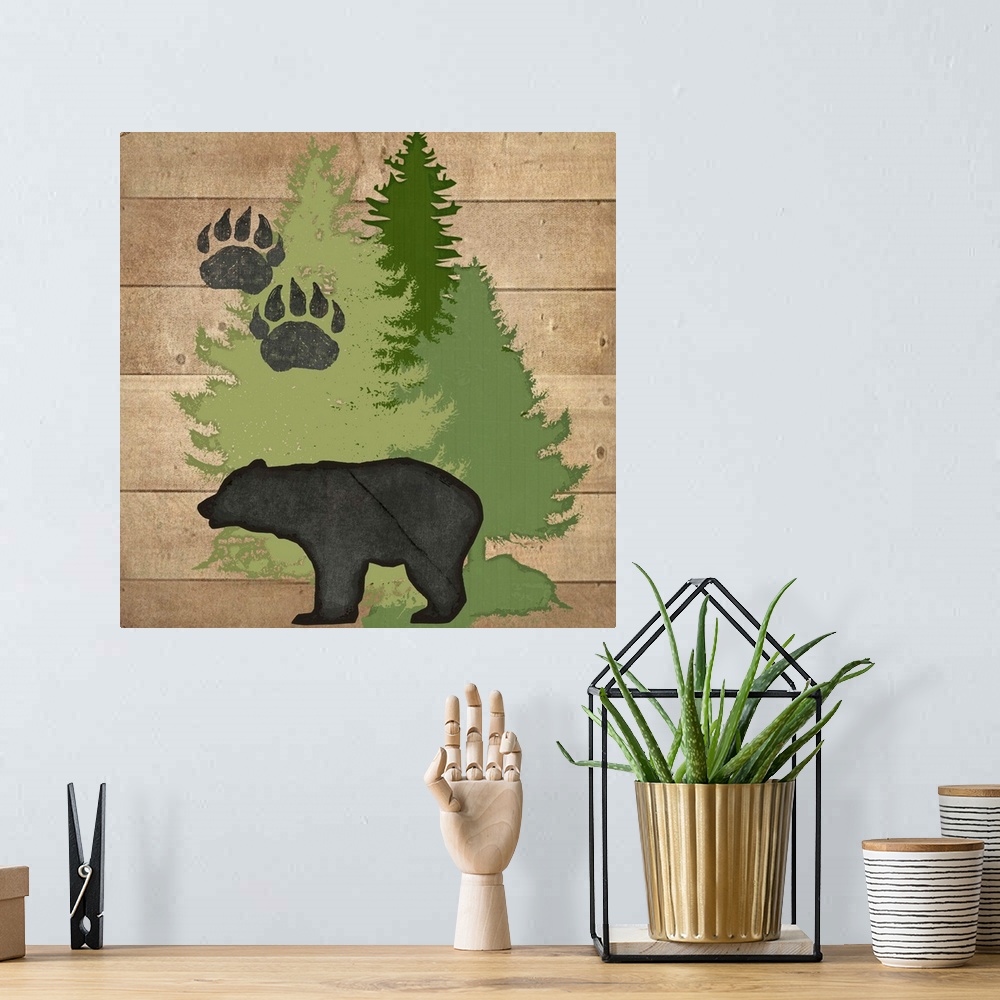 A bohemian room featuring Cabin decor of a bear silhouette with paw prints and pine trees.