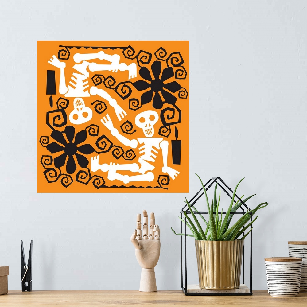 A bohemian room featuring Two skeletons with black flower designs on orange.