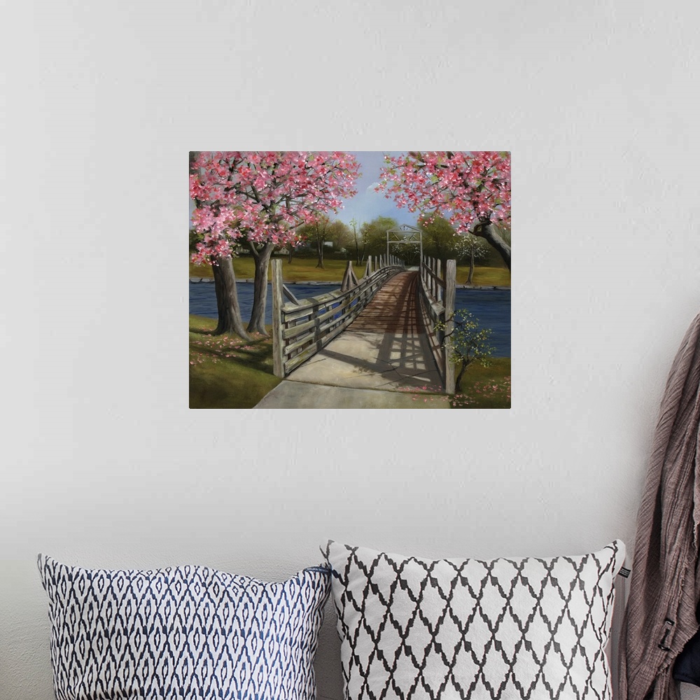 A bohemian room featuring A wooden bridge across a river under blossoming trees.