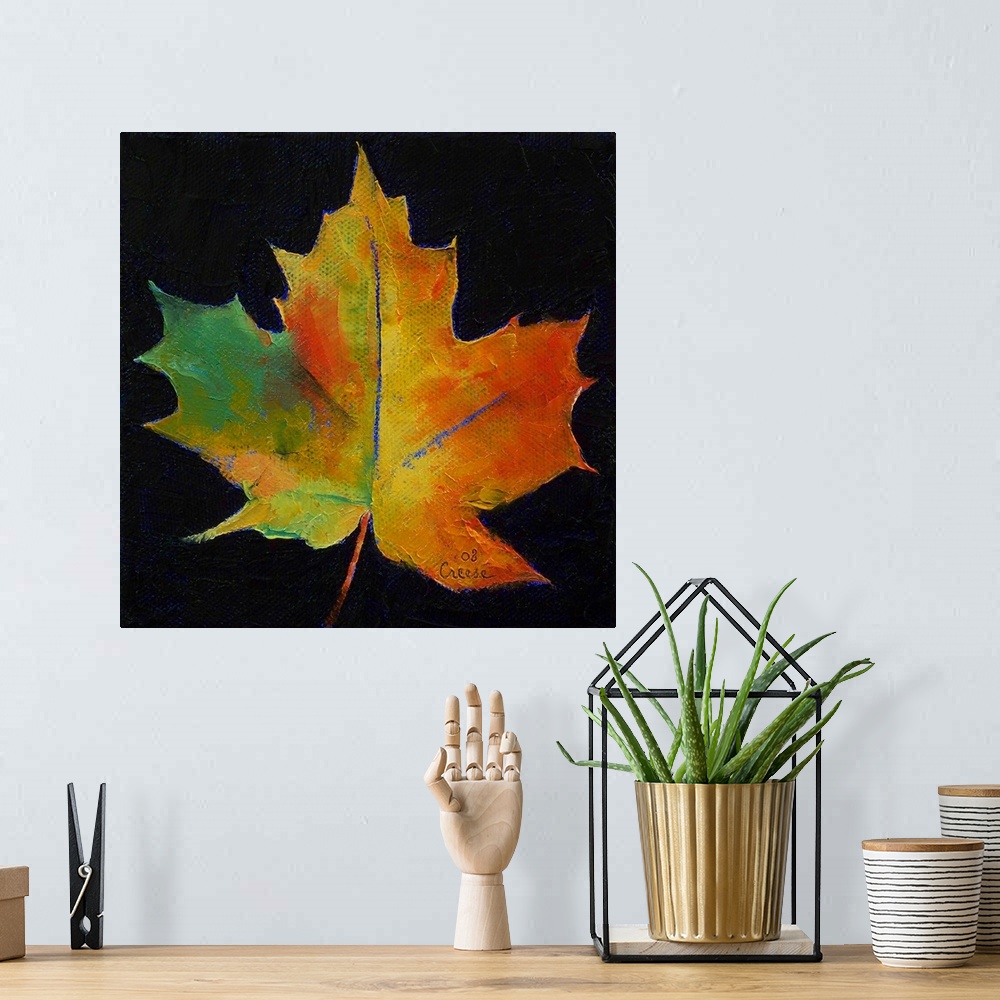 A bohemian room featuring Square painting on a large canvas of a vibrant, fall colored leaf on a black background.