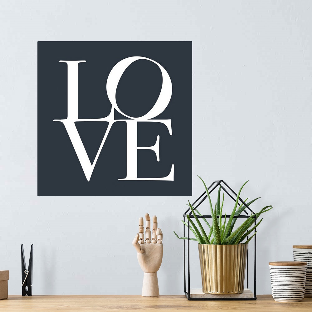 A bohemian room featuring LOVE, typography text art print and canvas print, with the word LOVE written against a slate grey...
