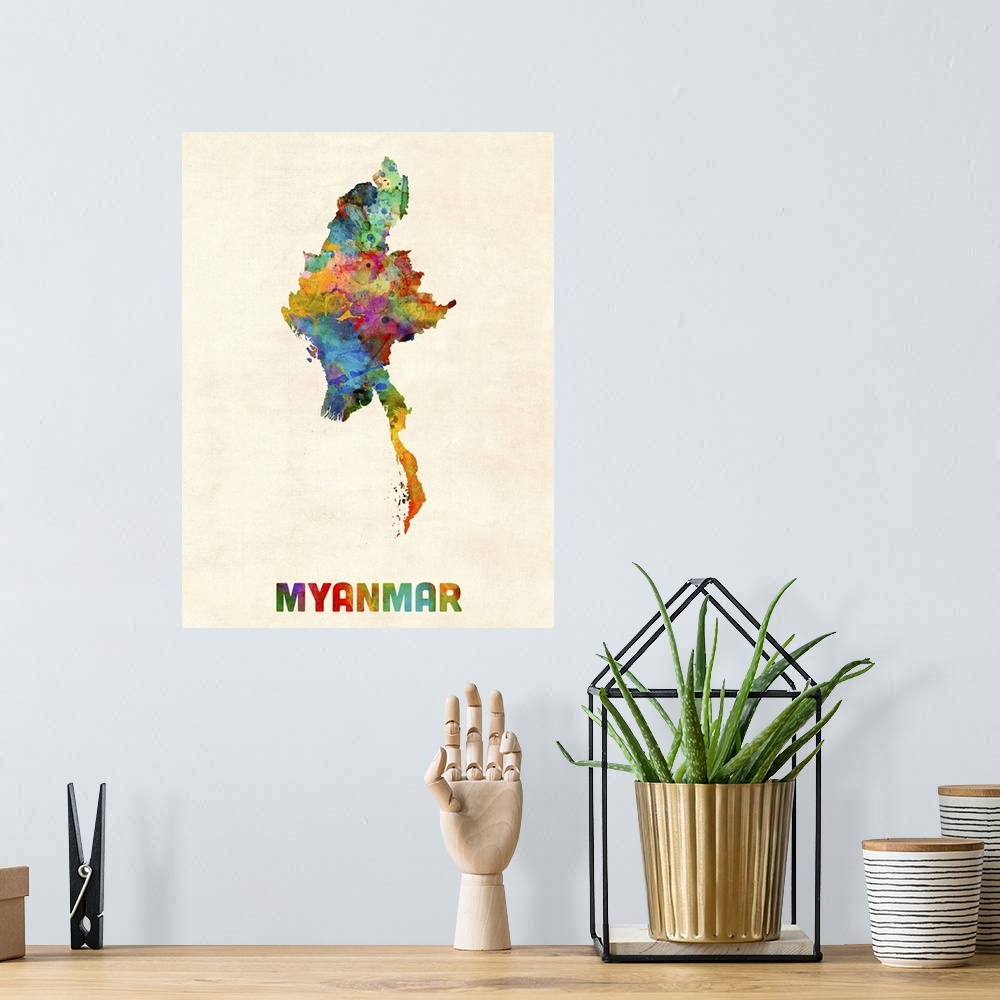 A bohemian room featuring Colorful watercolor art map of Myanmar against a distressed background.