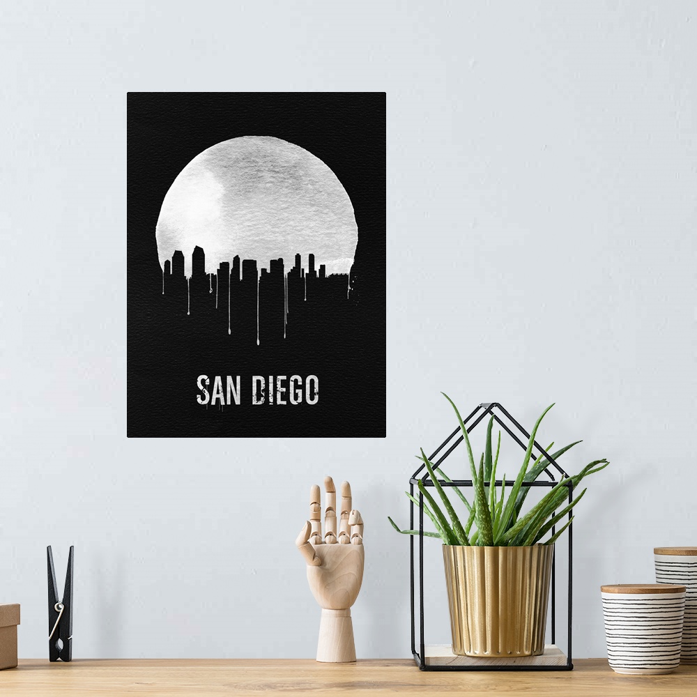 A bohemian room featuring Contemporary watercolor artwork of the San Diego city skyline, in silhouette.