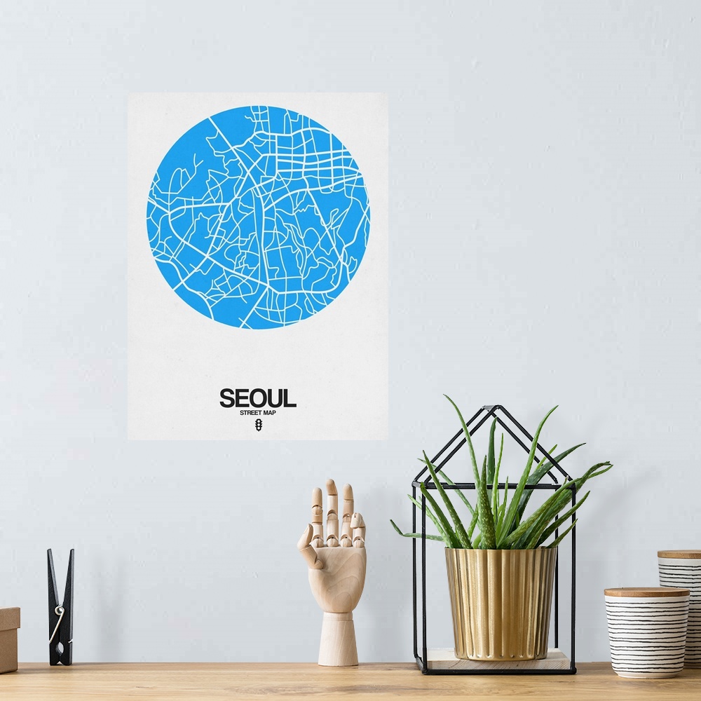 A bohemian room featuring Minimalist art map of the city streets of Seoul in white and blue.