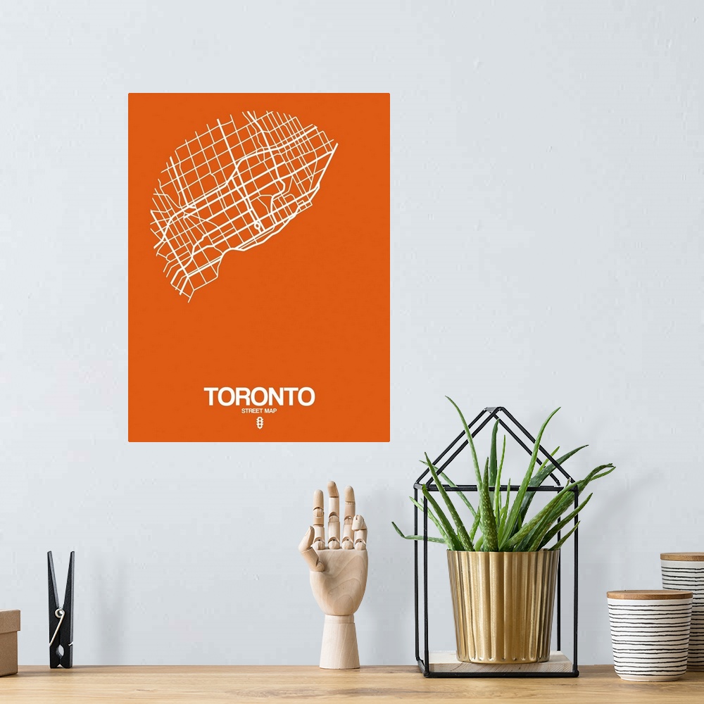 A bohemian room featuring Minimalist art map of the city streets of Toronto in orange and white.