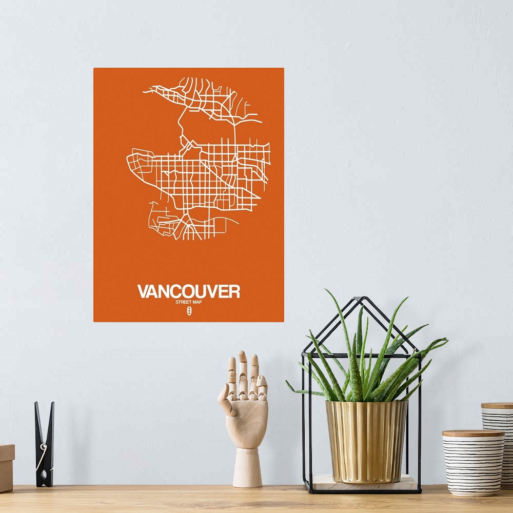 A bohemian room featuring Minimalist art map of the city streets of Vancouver in orange and white.