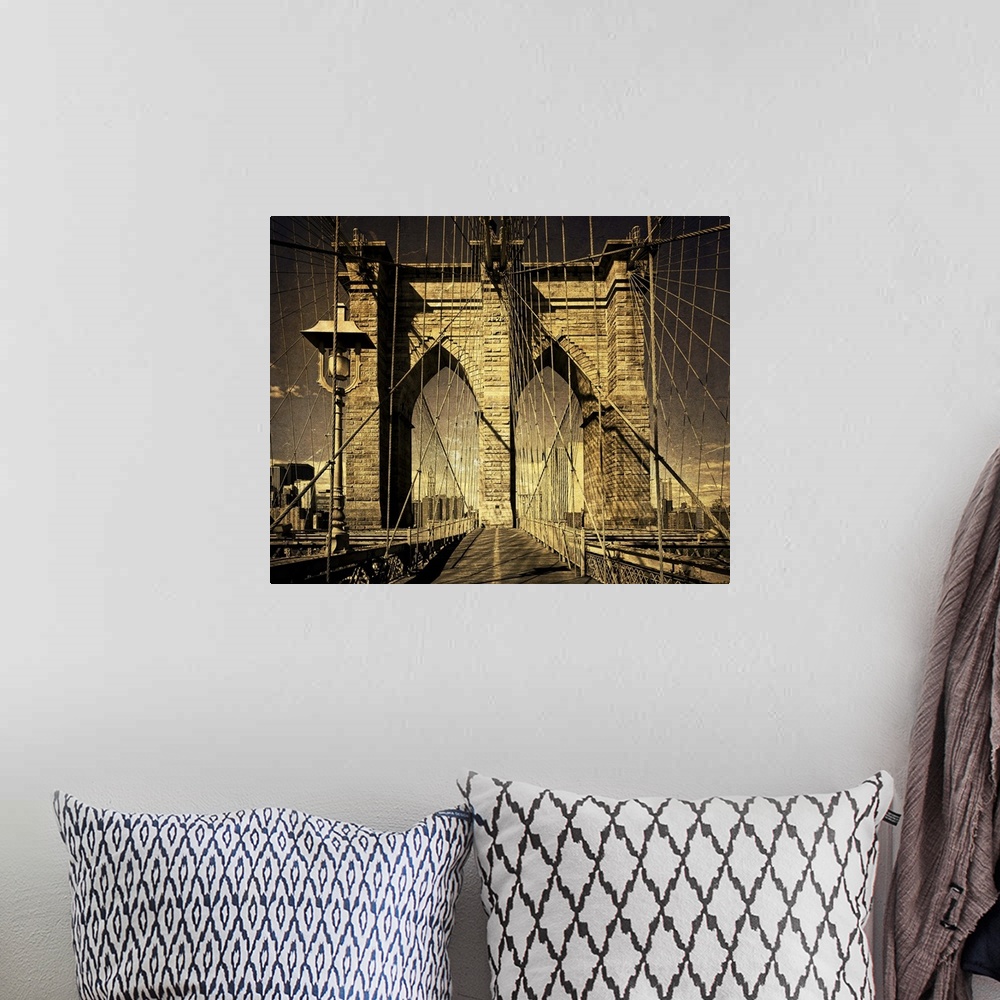 A bohemian room featuring Distressed photograph of the Brooklyn Bridge arches and suspension cables.