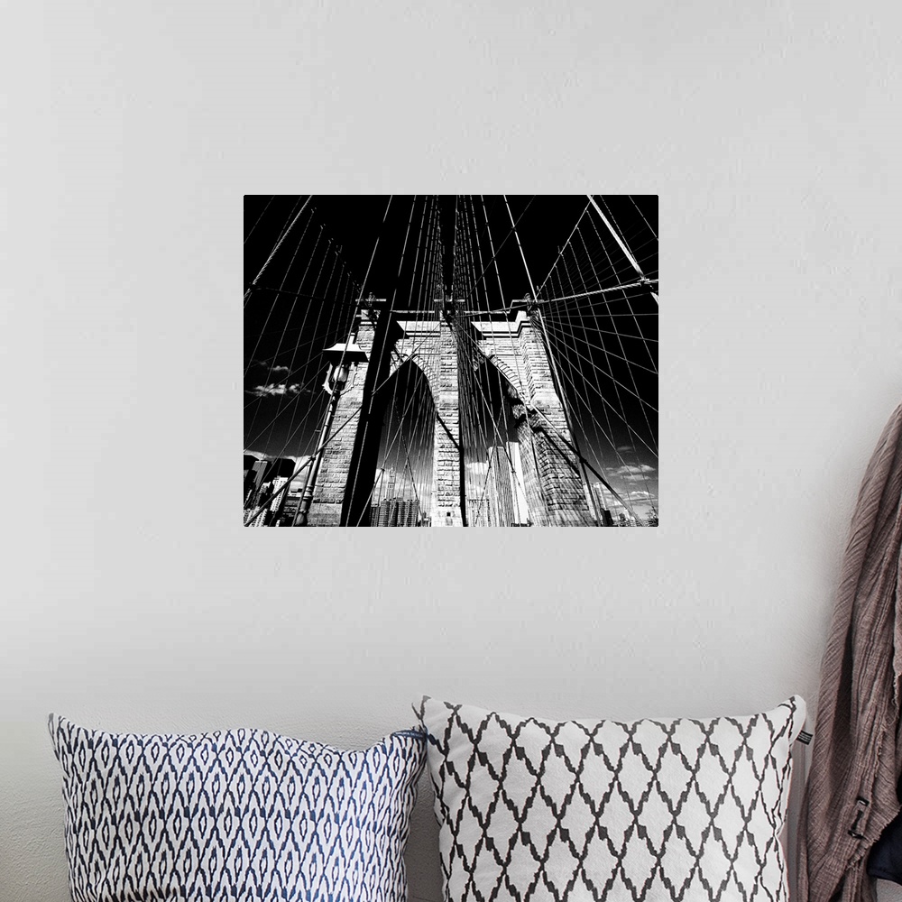 A bohemian room featuring Dramatic black and white photograph of the Brooklyn bridge arches and suspension cables.