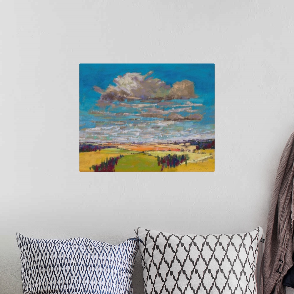A bohemian room featuring Pastel landscape painting of English countryside with trees, fields and clouds.