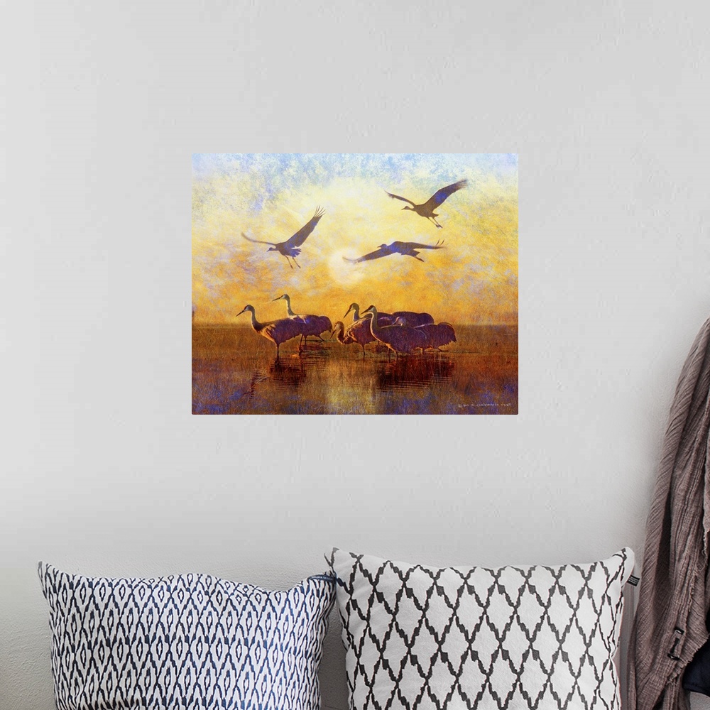 A bohemian room featuring Contemporary artwork of silhouetted cranes standing in water.
