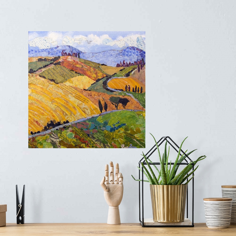 A bohemian room featuring Tuscan landscape with yellow rolling hills, purple mountains, and winding road.