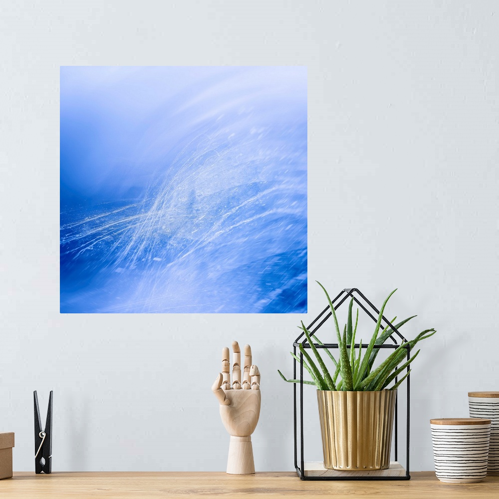 A bohemian room featuring Abstract photograph in blue and white with thin lines and splatter creating movement.