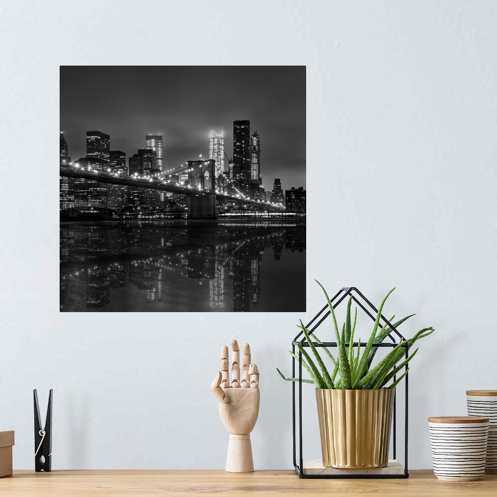 A bohemian room featuring Black and white photograph of New York city's skyline at night with the Brooklyn bridge in the fo...