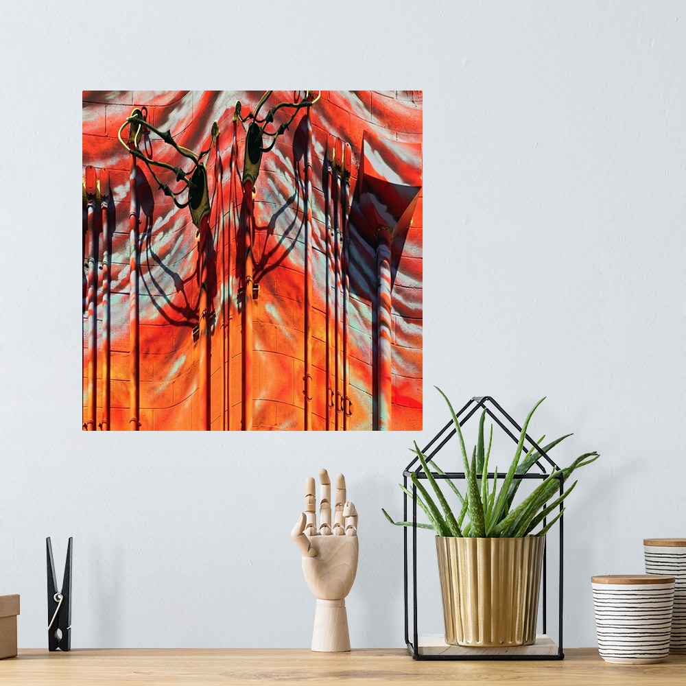 A bohemian room featuring Conceptual photo of red and orange painted pipes and wires on the side of a building, warped to c...