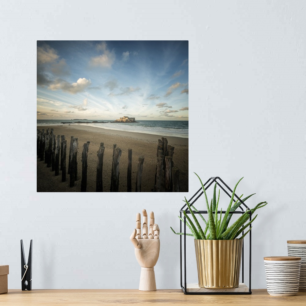 A bohemian room featuring Saint Malo in Brittany, France. Fort national under a dancing blue sky on a square picture.