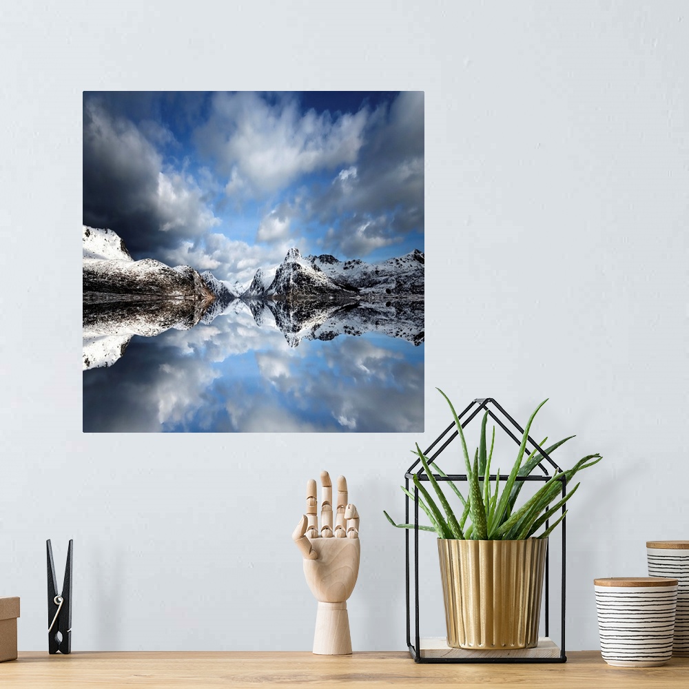 A bohemian room featuring Photograph of a lake casting a mirror reflection of mountains and clouds.
