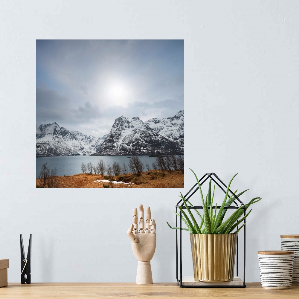 A bohemian room featuring Scenic photograph of snowy mountains and a lake under an overcast sky.