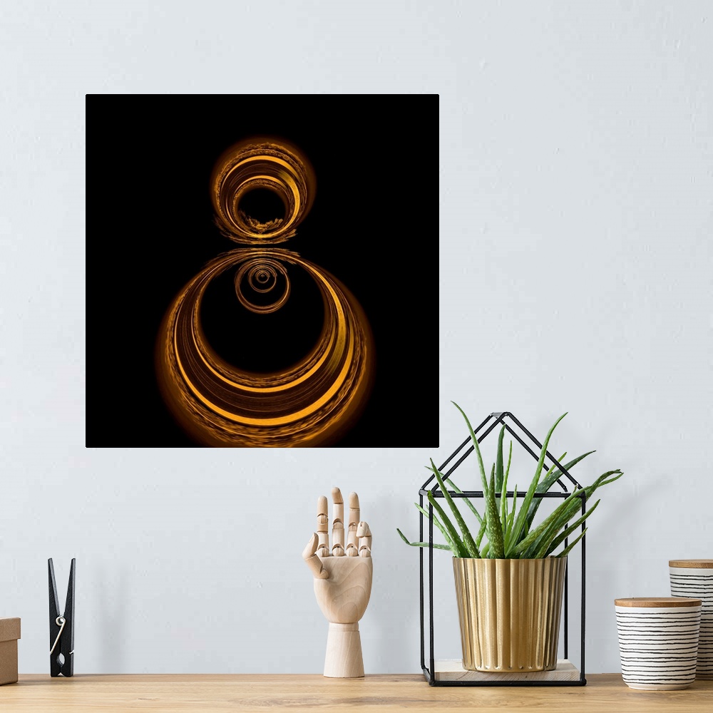 A bohemian room featuring Square abstract art with gold circles formed together on a black background.