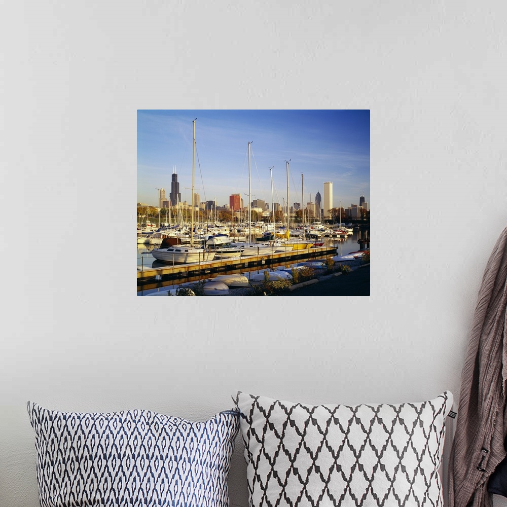 A bohemian room featuring This oversize piece is a picture taken of a line of boats docked in the waterfront near Chicago.