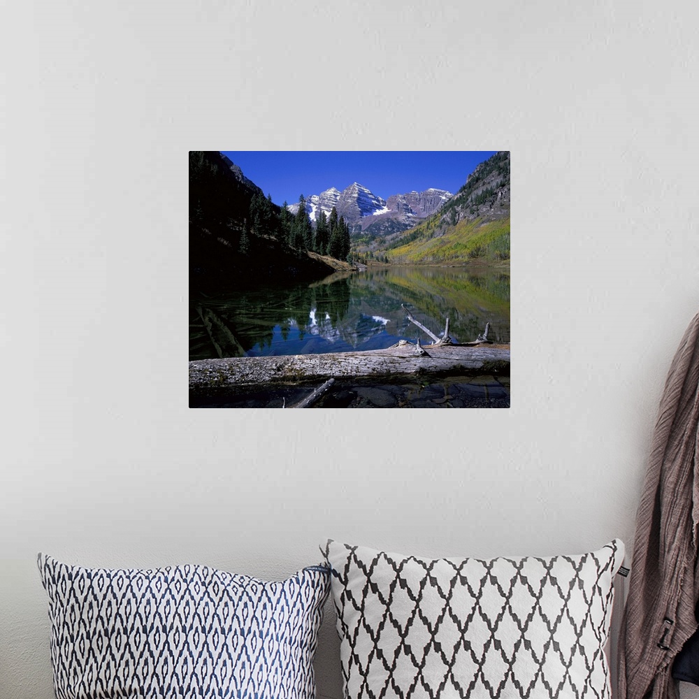 A bohemian room featuring Giant photograph of Maroon Bells, Colorado (CO) on a sunny day with a fallen tree trunk and lake ...