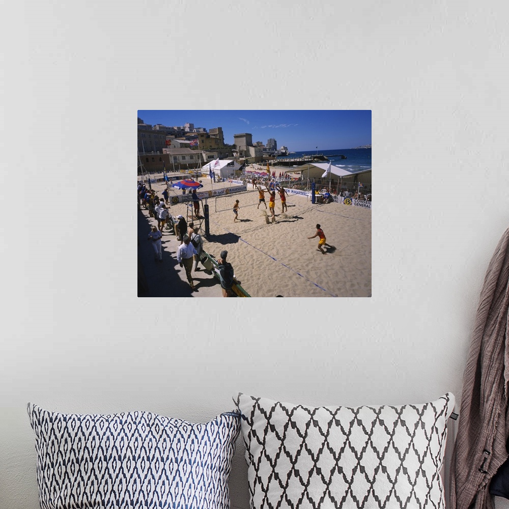 A bohemian room featuring High angle view of a group of men playing volleyball on the beach, Plage des Catalans, Marseille,...
