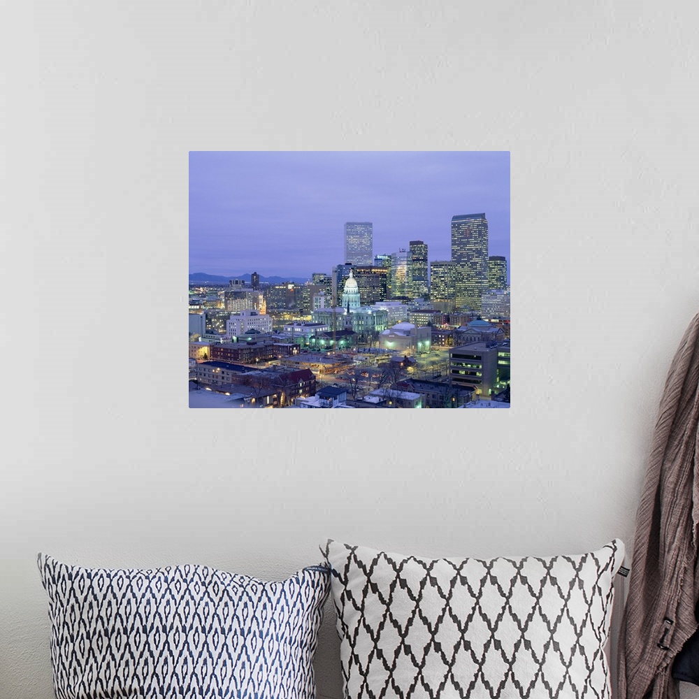 A bohemian room featuring Square canvas photo of a illuminated city at dusk with mountains in the left background.