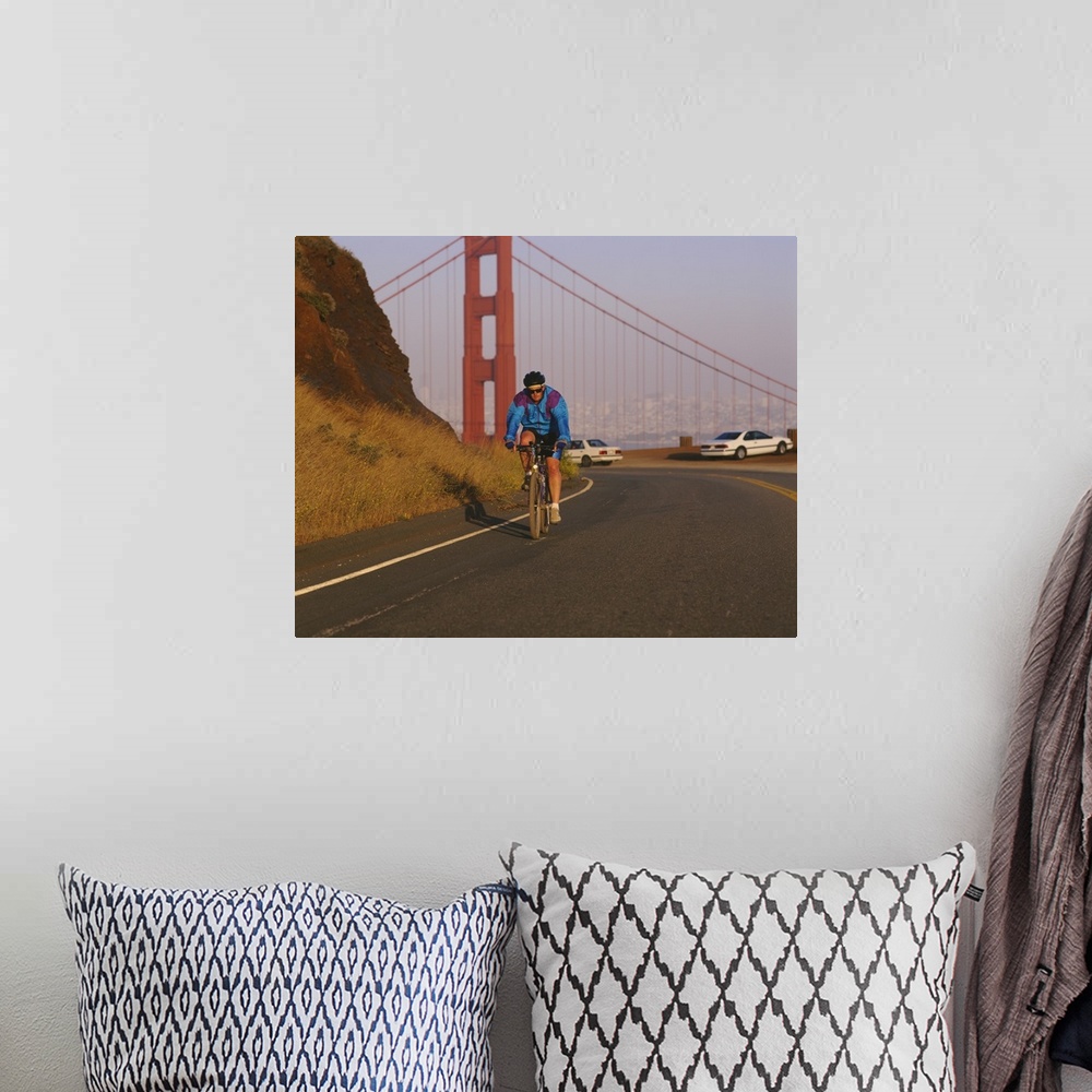 A bohemian room featuring Mid adult man cycling, Golden Gate Bridge, San Francisco, California