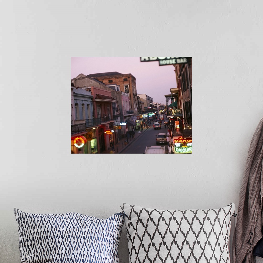 A bohemian room featuring Landscape, large photograph looking down Bourbon Street in New Orleans, Louisiana.  Rows of store...