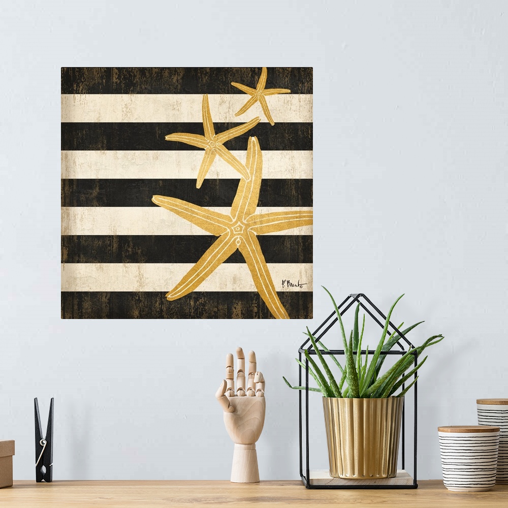 A bohemian room featuring Square decor with metallic gold starfish on a black and white striped background.