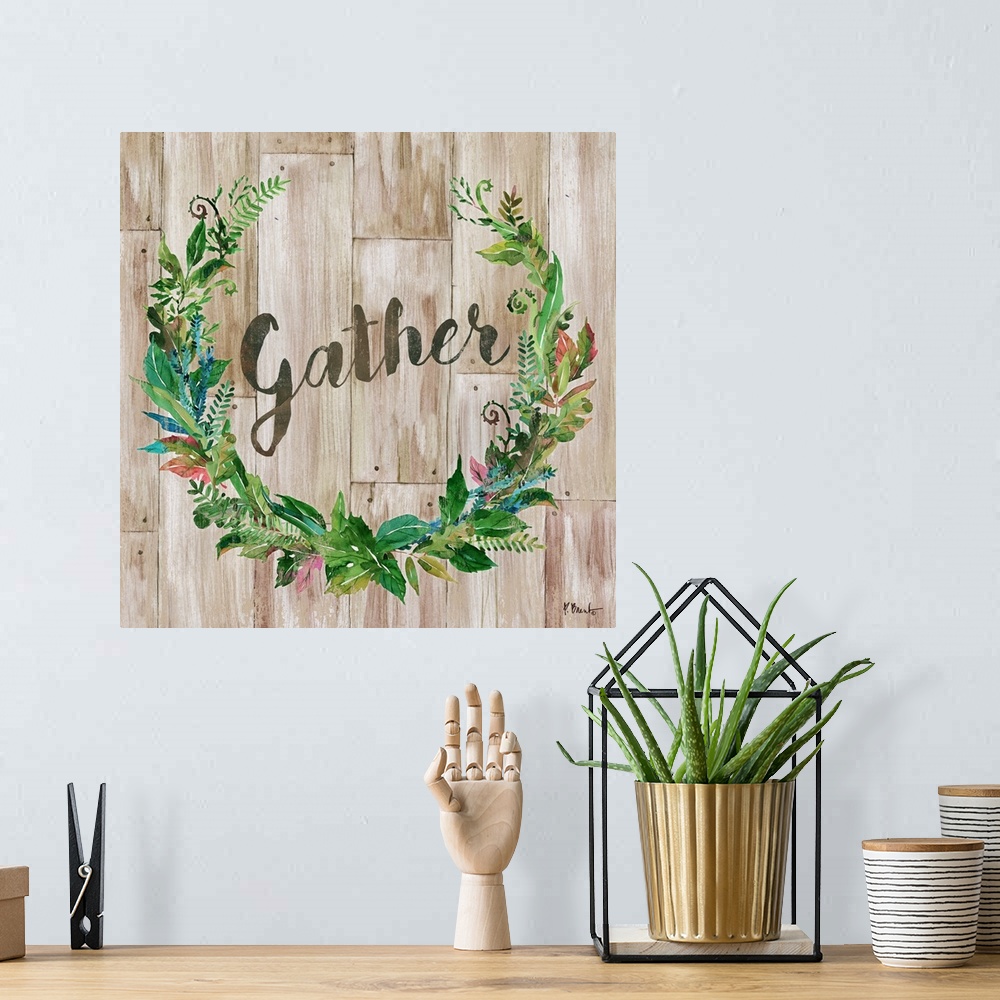 A bohemian room featuring "gather" written inside a leafy green wreath on a faux wood background.