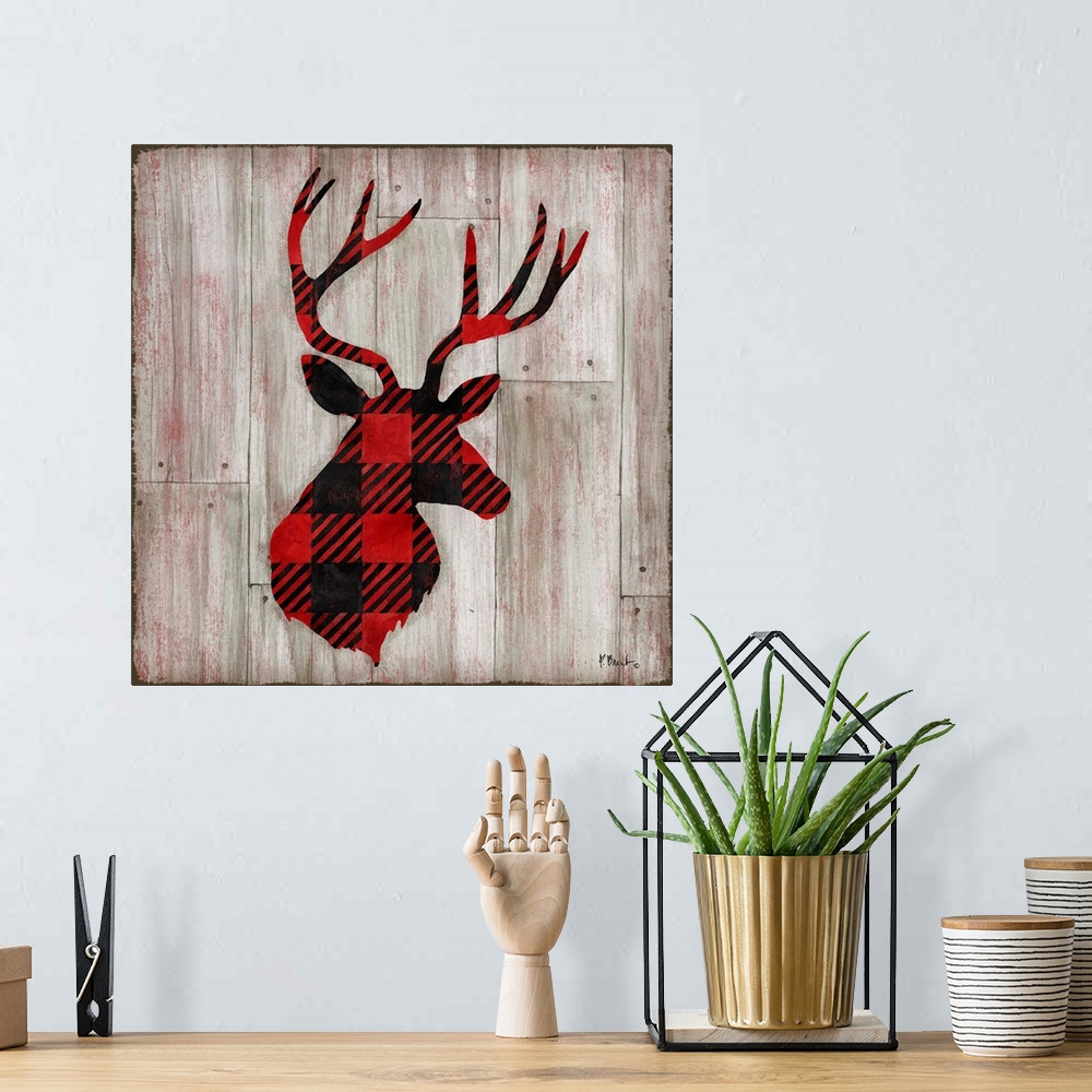 A bohemian room featuring Square cabin decor with a red and black flannel patterned silhouette of a deer on a faux distress...
