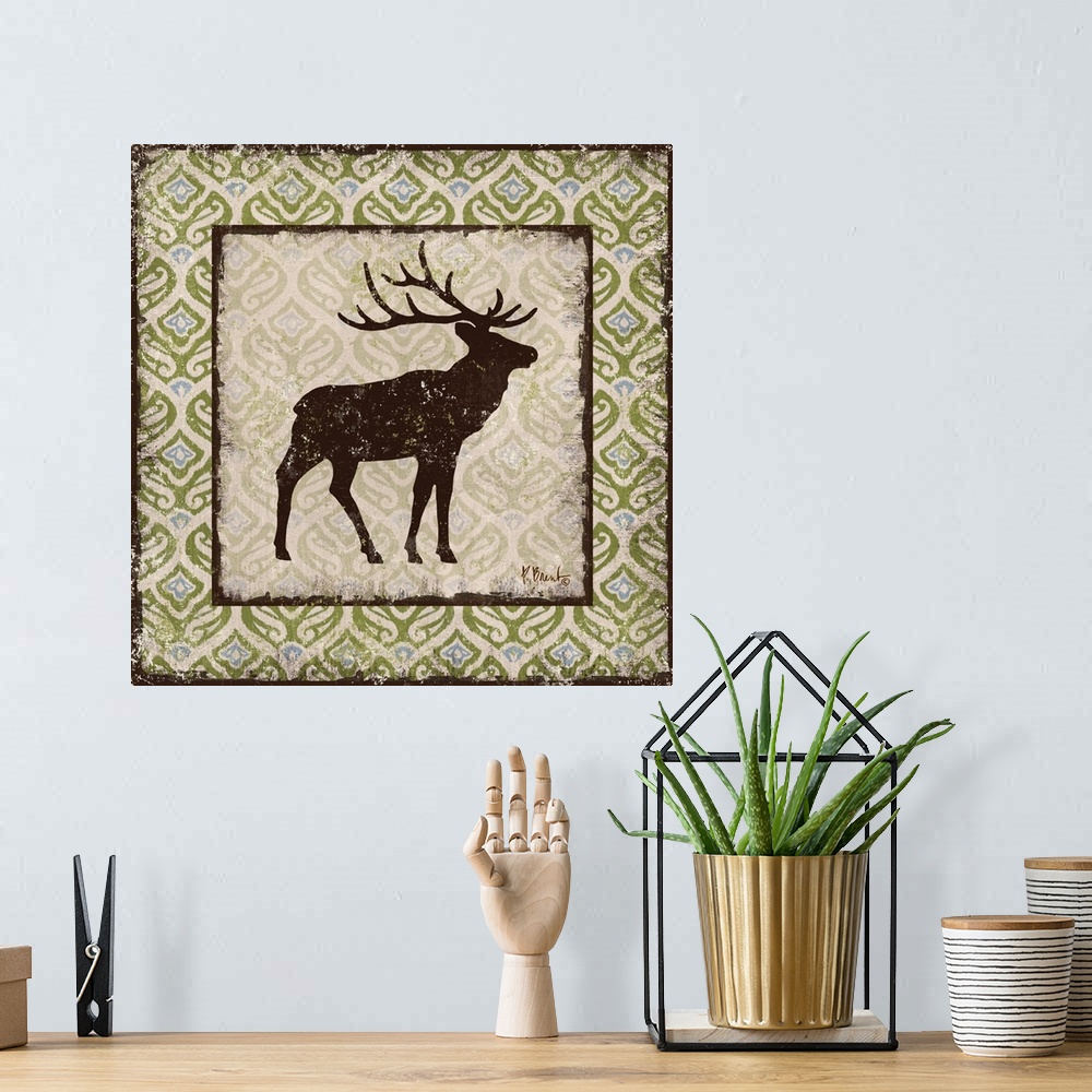 A bohemian room featuring Decorative square artwork featuring a silhouetted elk on a boho pattern.