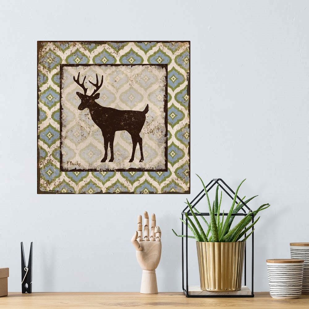 A bohemian room featuring Decorative square artwork featuring a silhouetted deer on a boho pattern.