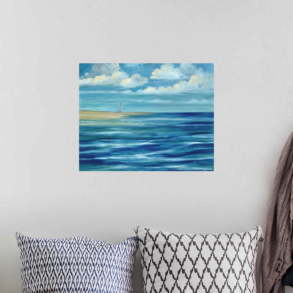 A bohemian room featuring Contemporary artwork of a lighthouse on the coast, seen across the ocean under a cloudy sky.