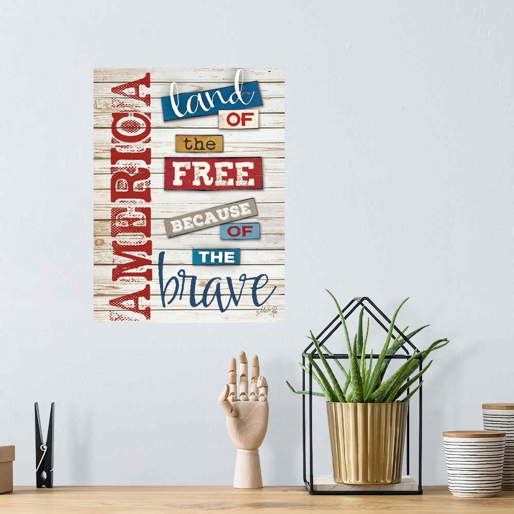 A bohemian room featuring Patriotic typography art in red white and blue against white distressed wooden boards.