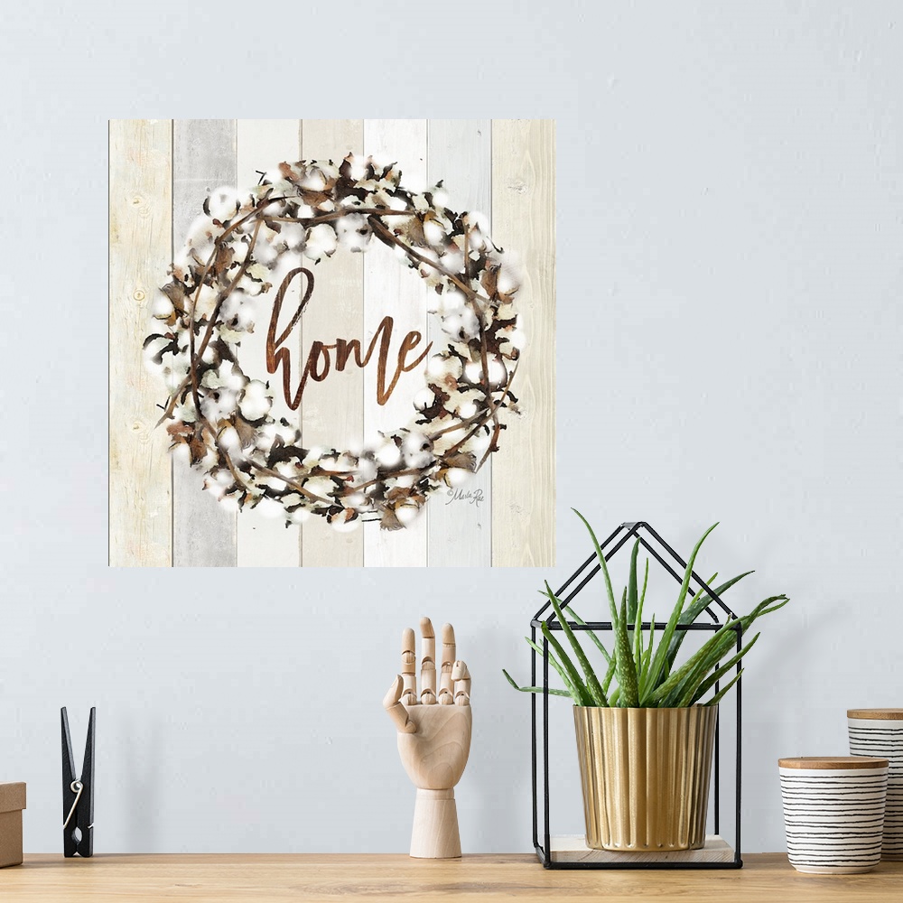 A bohemian room featuring "Home" in the middle of a wreath of cotton against a shiplap background.