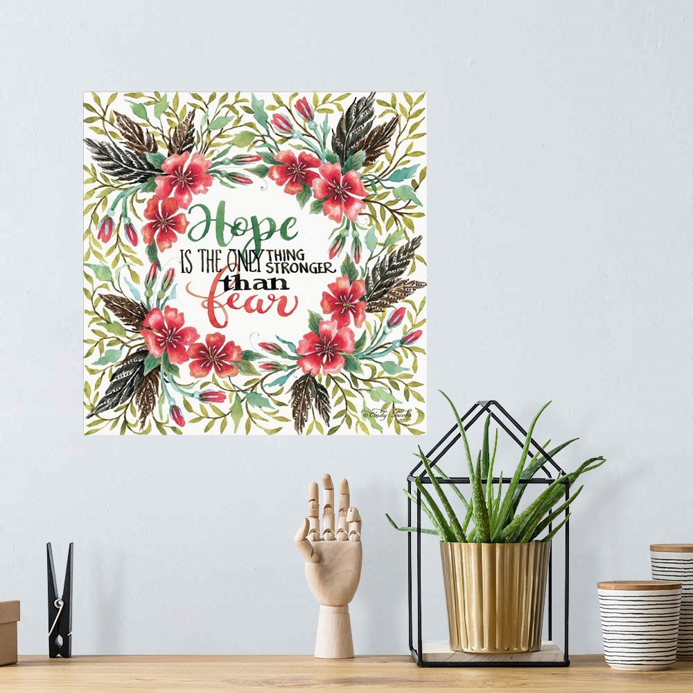 A bohemian room featuring Handlettered sentiment in a wreath of red poppies with dark leaves.