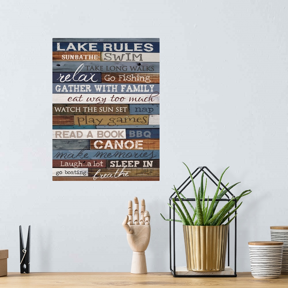 A bohemian room featuring Typography artwork of lake rules, with text against a wooden background.