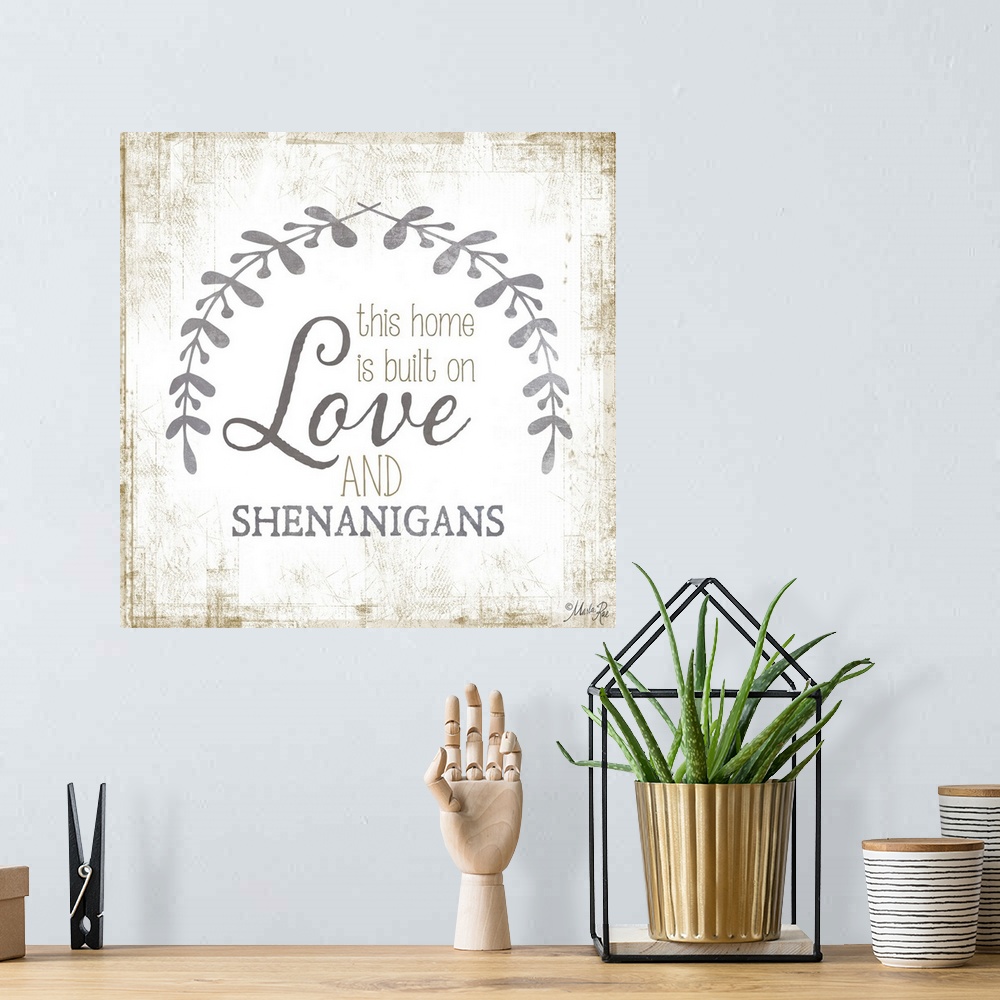 A bohemian room featuring Phrase about family love framed by two leafy sprigs on a textured background.