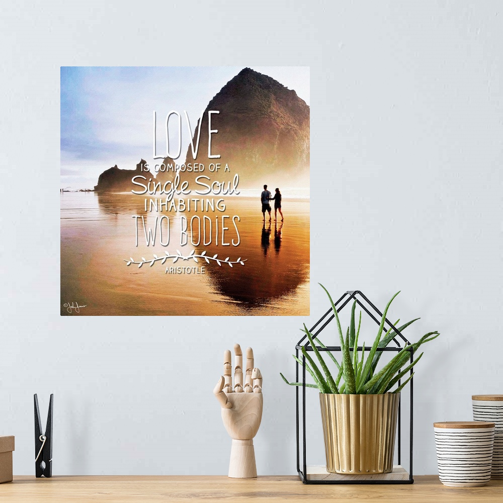 A bohemian room featuring Sentiment in white lettering against a photograph of a silhouetted couple walking along a beach.