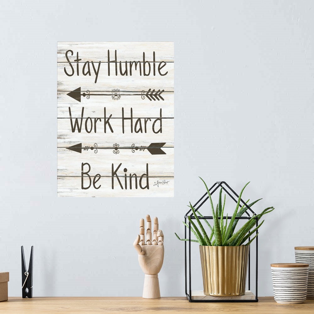 A bohemian room featuring This decorative artwork features the phrase: Stay humble, work hard, be kind, over a distressed w...