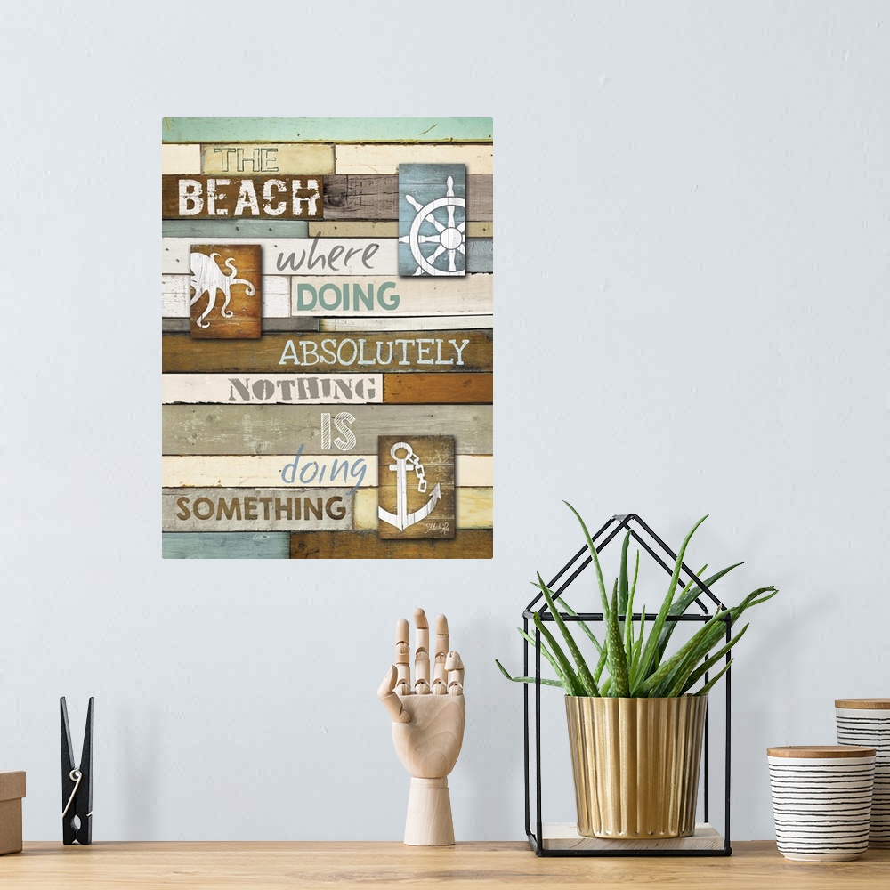 A bohemian room featuring Cute coastal typography art on wooden boards with an anchor and octopus.