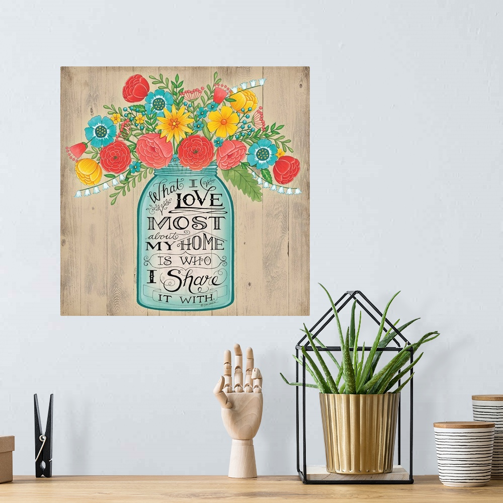 A bohemian room featuring A bouquet of colorful flowers in a mason jar with decorative lettering.