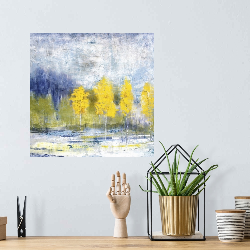 A bohemian room featuring Brilliant landscape of a row of yellow leaved trees before a forest and blue sky.