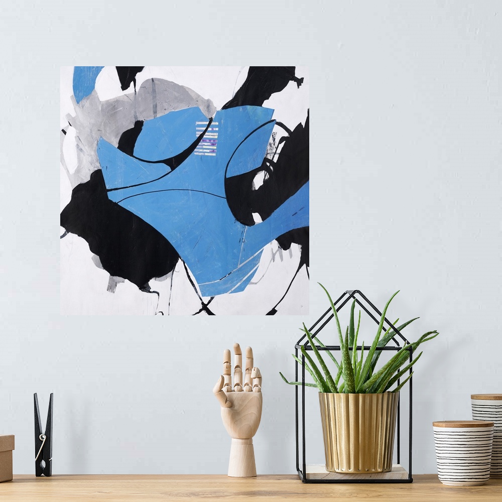 A bohemian room featuring Square blue, black, and gray abstract with thin black curvy lines.