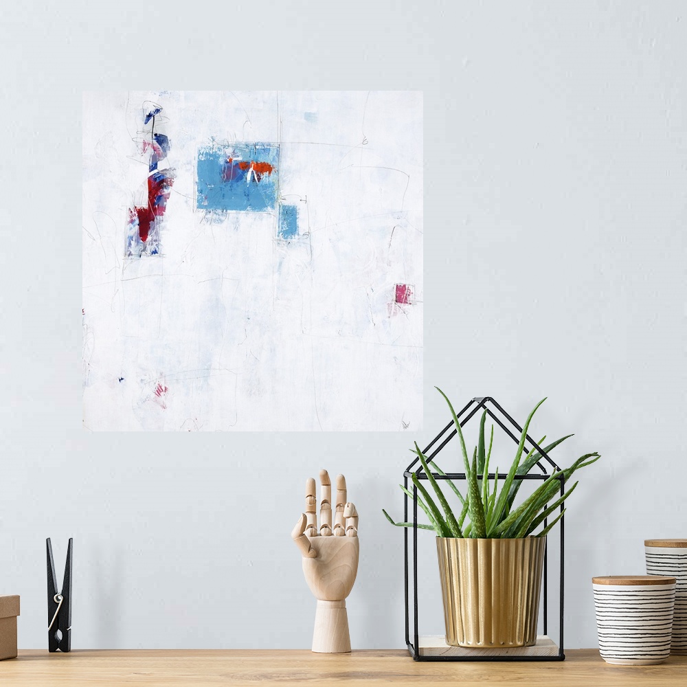 A bohemian room featuring Contemporary abstract painting using splashes of vibrant blue and red against a neutral environment.