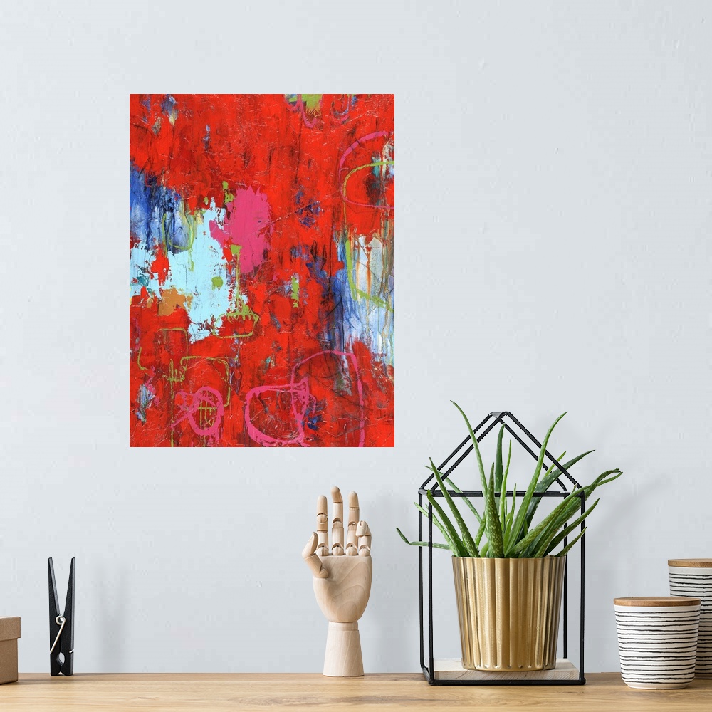A bohemian room featuring Large abstract painting with bright red hues with pink and green lines on top and shades of blue ...